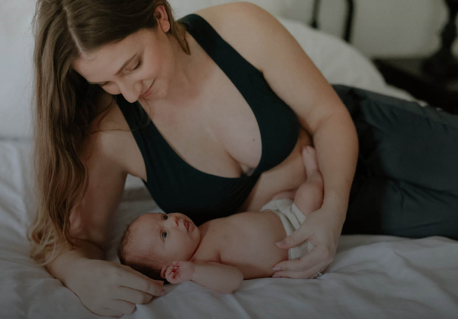 woman sitting breastfeeding her baby