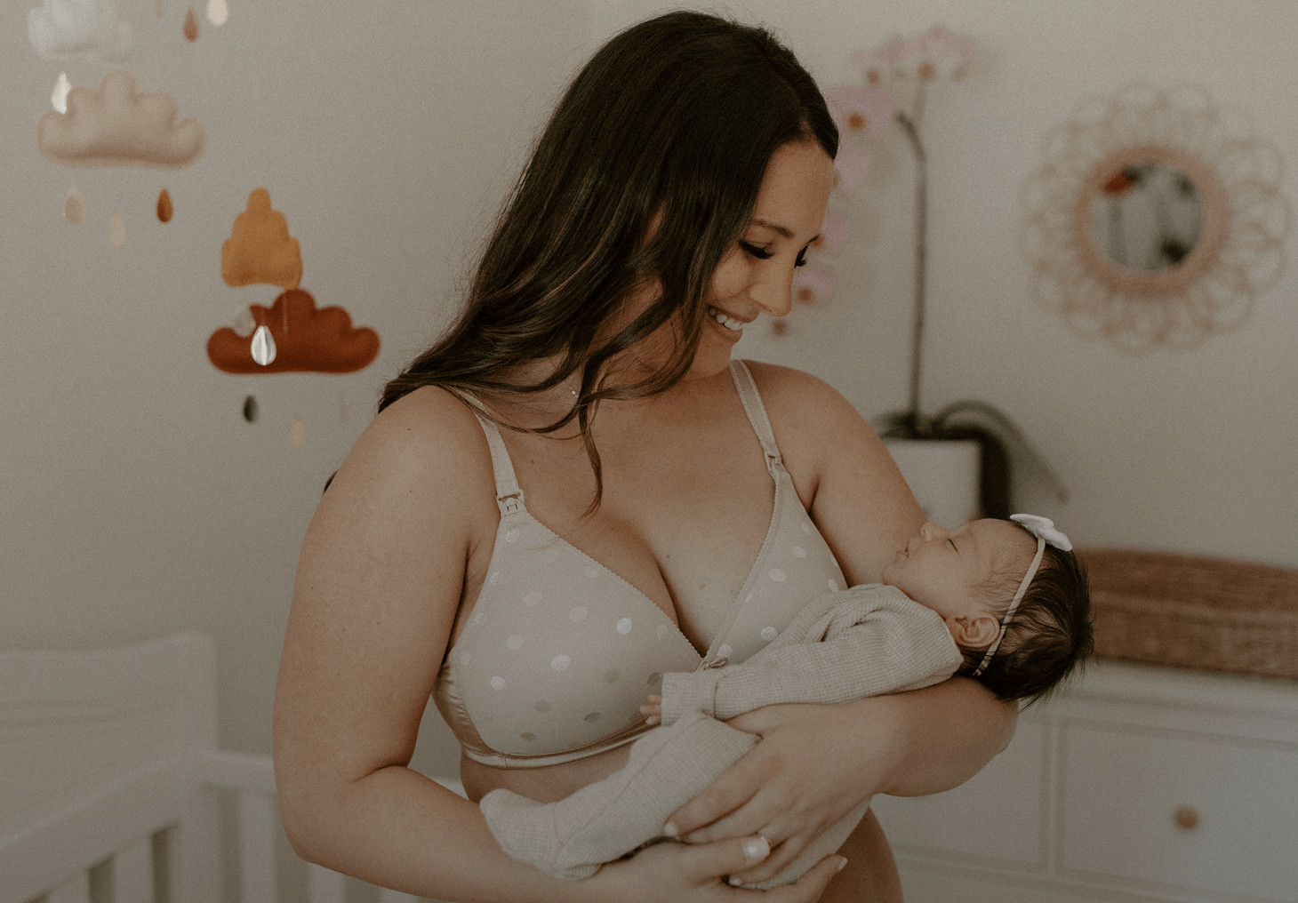 woman sitting breastfeeding her baby