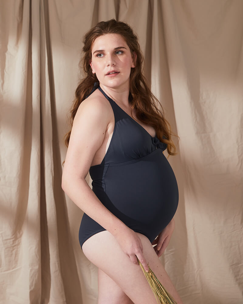 pregnant woman wearing tonic pregnancy swimsuit