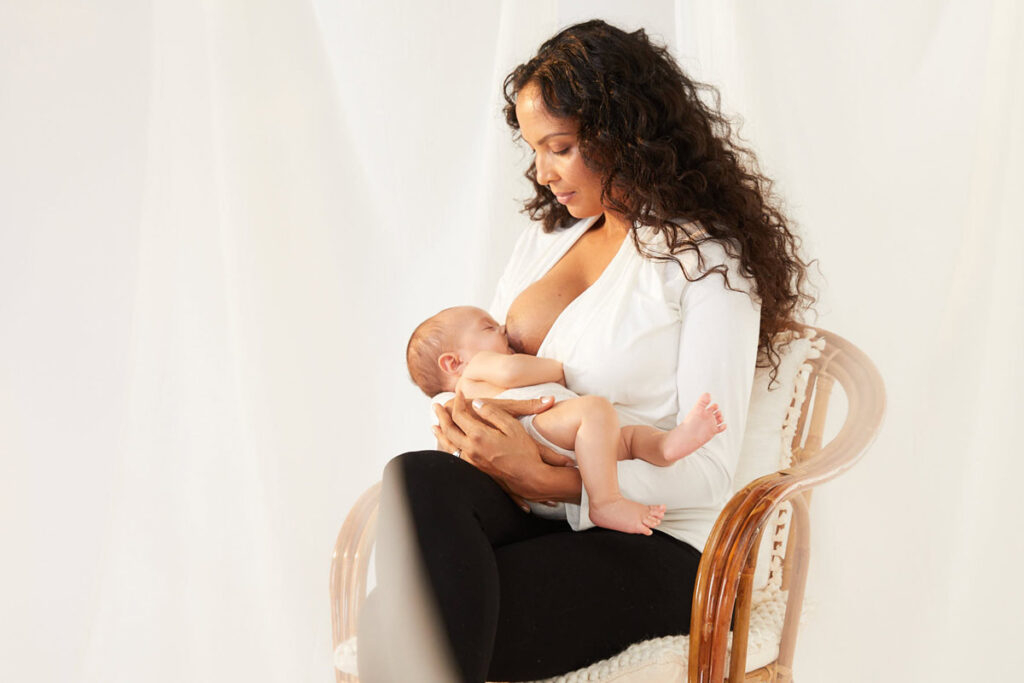 woman wearing tic tac nursing top while breastfeeding