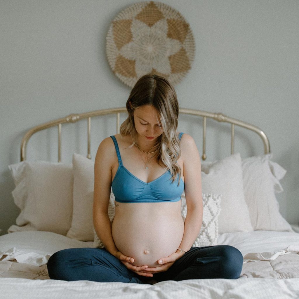 pregnant woman sitting in bed