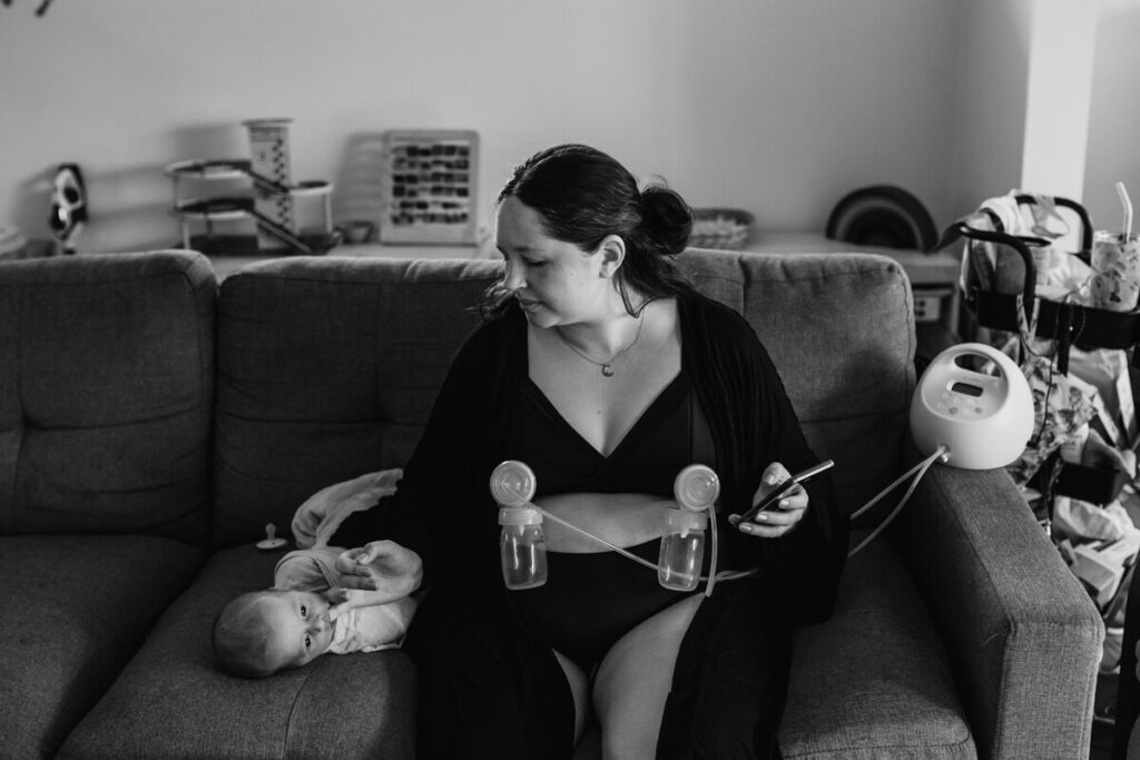 woman pumping with newborn