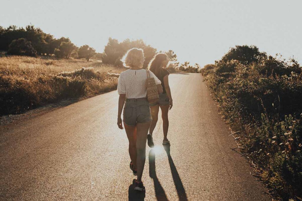 women walking on the road